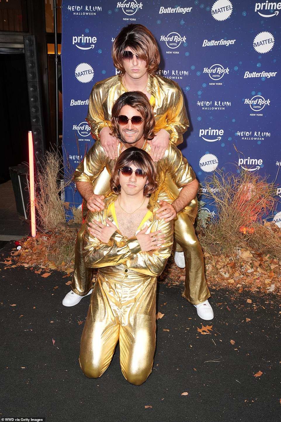 The performer was in good company on the night as he fiancé Thom Evans , 39, [centre] was also in attendance, with the rugby ace donning a gold ensemble and brunette wig as he posed with pals Diego Rodriguez and Tom Francis