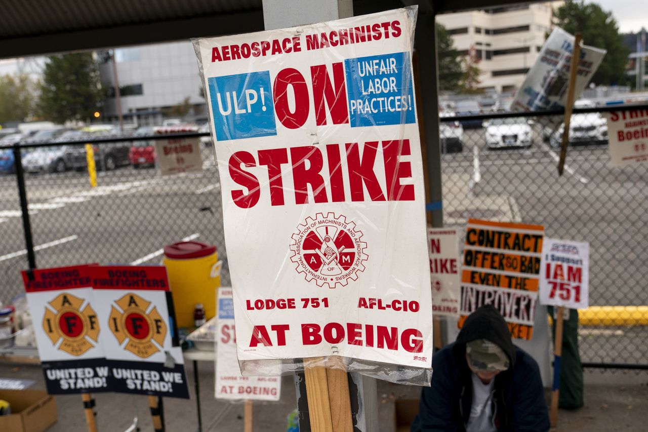 A strike sign is seen on display as Boeing workers gather on a picket line near the entrance to a Boeing facility during an ongoing strike on October 24 in Seattle, Washington.