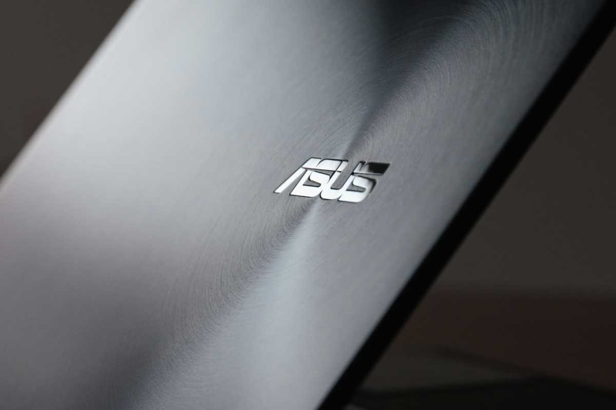 ASUS logo glossy on laptop lid that's cracked open but not all the way